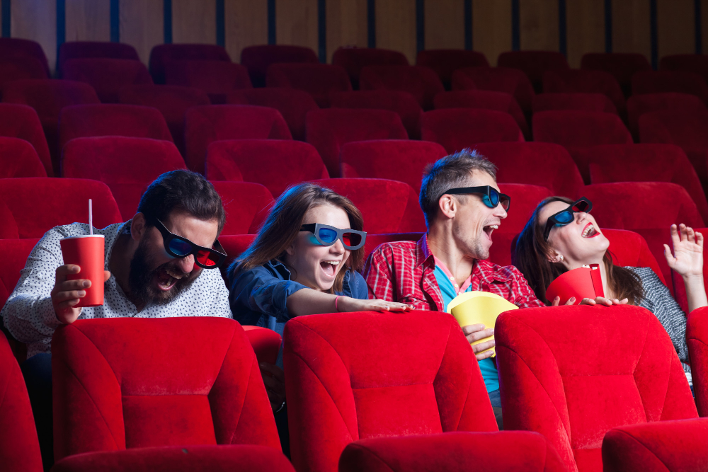 people watching movie in a theatre with 3-D glasses for entertainment