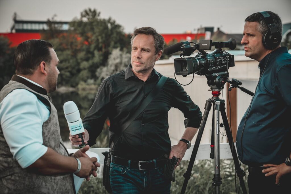 a news reporter with cameraman taking an interview from a man