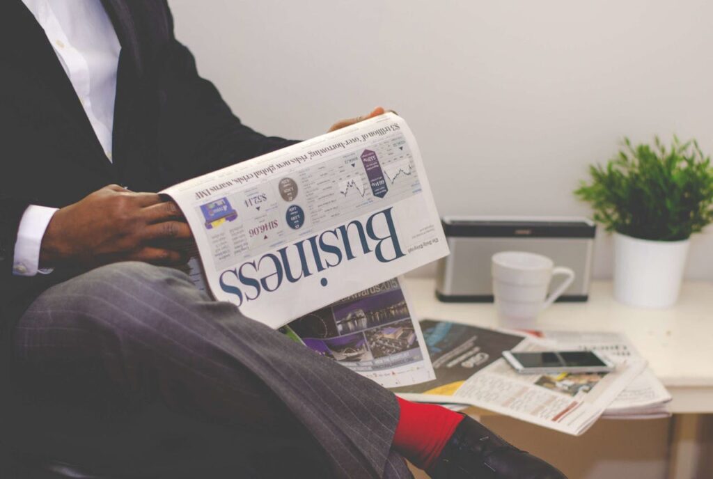 A man reading news from a newspaper